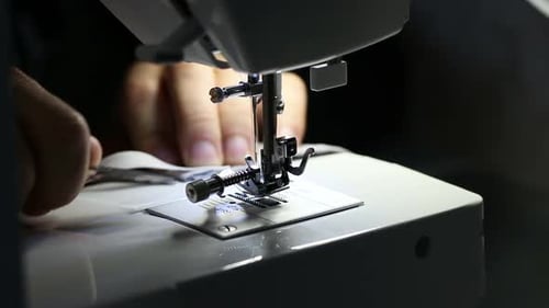 With Small Metal Scissors Preparing Sewing Thread In Sewing Machine. Close-Up Slow-Motion Footage.