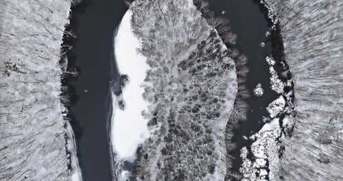 River and snowy forest in winter. Aerial view of nature.