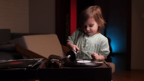 Little Girl Plays With Vintage Record Player