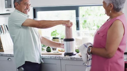 Couple Making Healthy Smoothie in Bright Kitchen