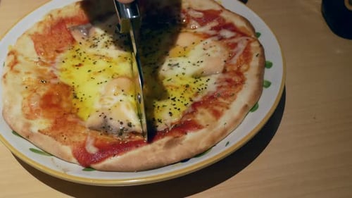Cutting Fresh Pizza on Plate with Rolling Cutter