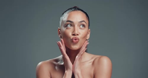 Skincare, pout and smile with hands and woman in studio for aesthetic, self care and collagen glow