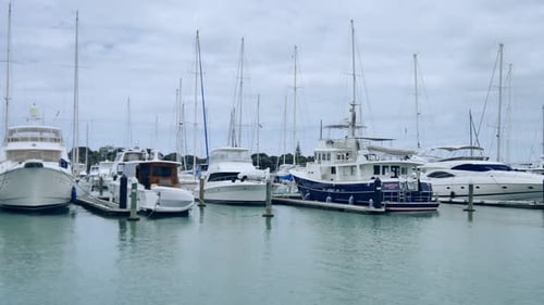 wide shot of a marina with boats & yacht