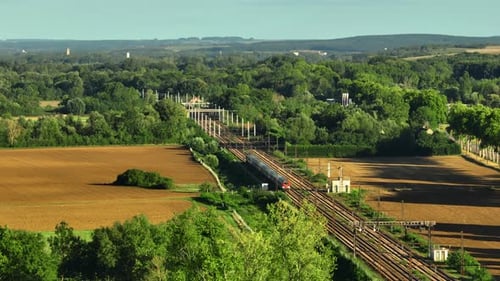 Railway in the Countryside and Trains Passing Aerial View Beautiful Green Scenery in France Nature