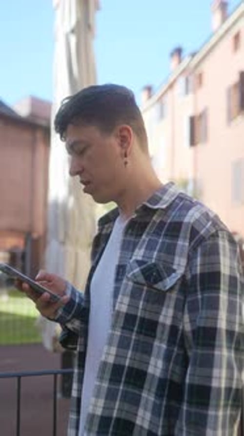 Young Adult Using Smartphone in Urban Setting