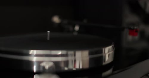 Hand Placing White Record on Record Player