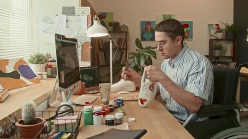 Young Adult Customising Shoe with Paint at Desk