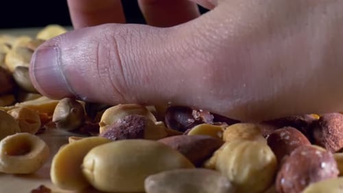 Mixed Nuts Macro Shot with Hand Reaching In