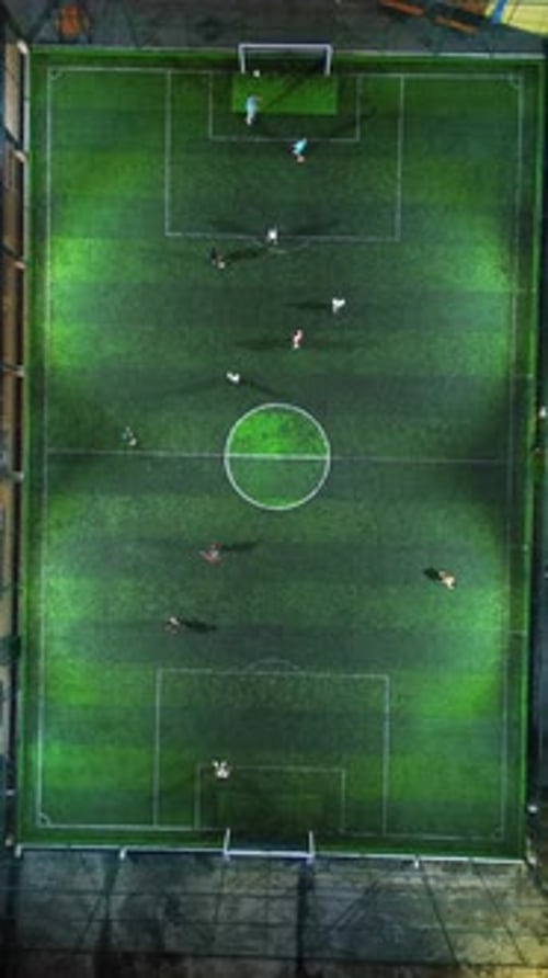 Vertical Drone Footage of mini football match, soccer. MiniFootball field and Footballers from drone