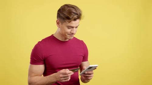 Caucasian Man Using the Mobile and Card to Shopping Online