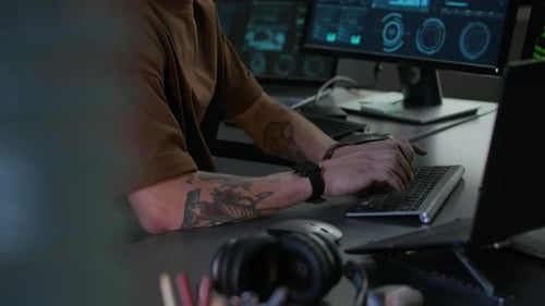 Concentrated Young Male Programmer Working on PC in Modern Programmers Office