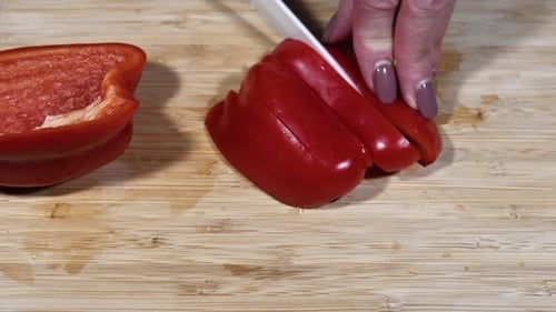 Slicing a Red Bell Pepper on Cutting Board