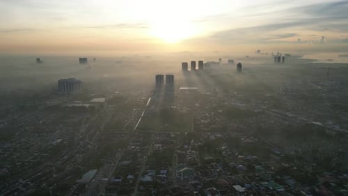 Aerial misty Larkin city with a foggy sky and a sun in the background