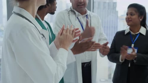Medical Staff Clapping and Celebrating in Modern Office