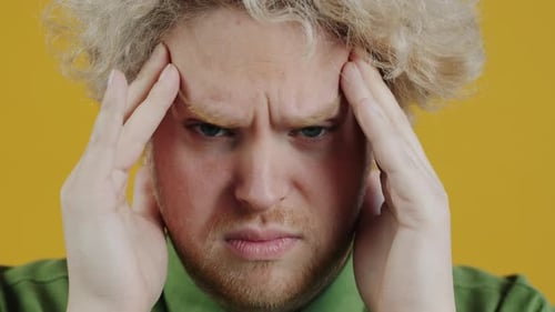 Man Massaging Temples Due To Headache Pain