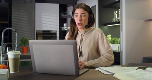 Young Woman Video Conferencing in Modern Kitchen