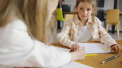 Children Drawing Together at School Classroom Table