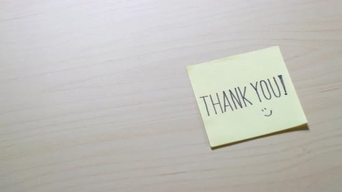 Thank You Note on a Beige Wood Table