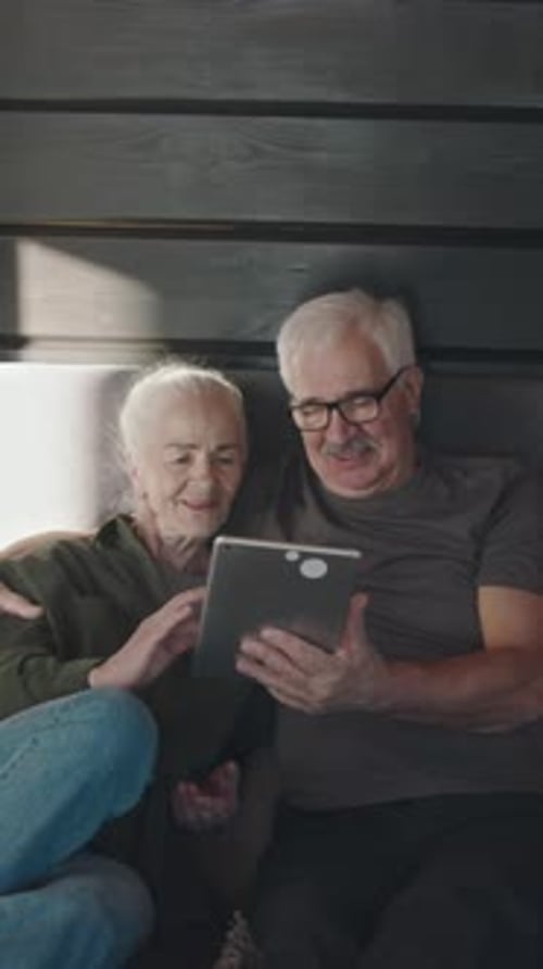 Senior Couple Relaxing and Using Tablet Together