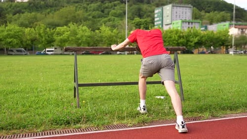 Young Man Stretching and Warming Up for Run