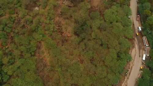 Vehicles Drive On Curve Road, Reveals Cityscape With Crowded Buildings In New Delhi, India. - aerial