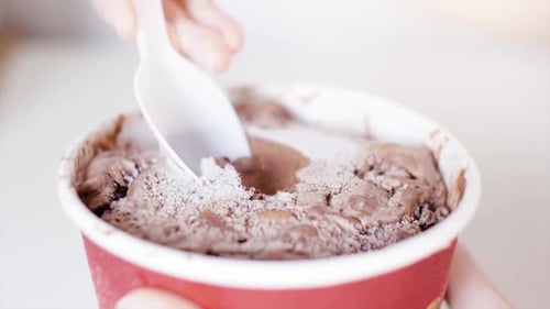 Eating Chocolate Ice Cream in a Red Container