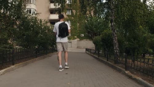 Man Walking Down City Street