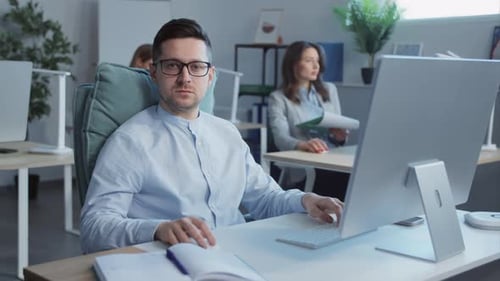 Man Working on Computer in Modern Office