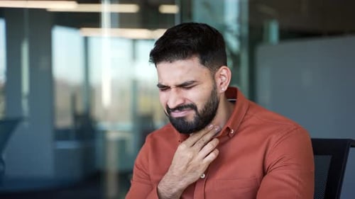 Man Suffering From Sore Throat in Office
