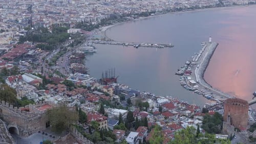 View of Alanya and harbour with ships at evening. Time-lapse.