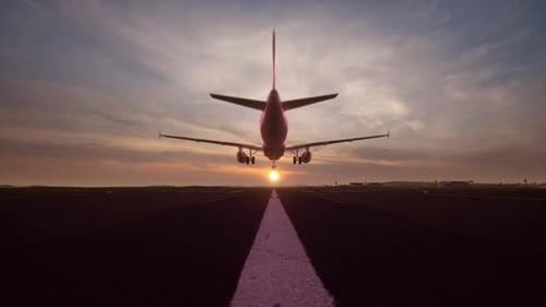 Airplane Approaching Landing on Runway at Sunset