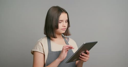 Young Woman Using Tablet Device in Studio