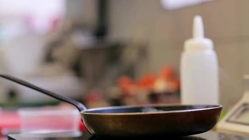 Frying pan with steam in kitchen