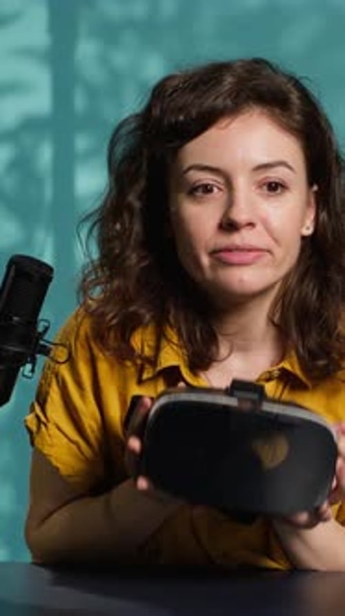 Woman Demonstrating Virtual Reality Headset at Her Desk