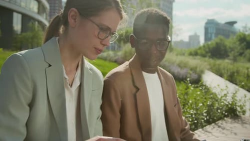 Business Professionals Working Outdoors in an Urban Park