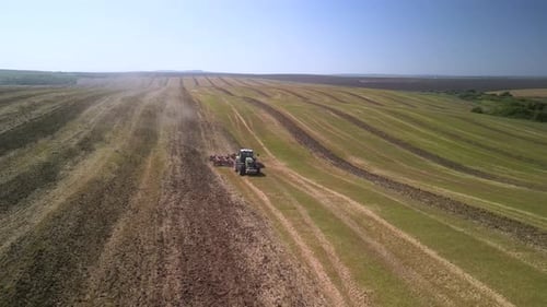 Tractor working on the field doing tillage with cultivator