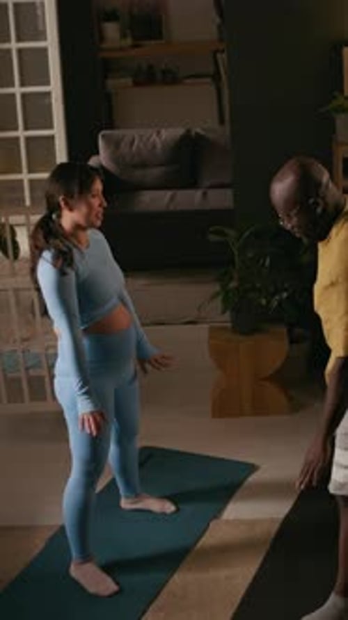 Healthy Interracial Couple Doing Yoga Together at Home