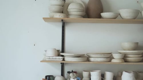 handmade crockery on a shelf in a pottery workshop