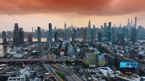 New York cityscape divided by beautiful river. Panorama of the metropolis at sunset.