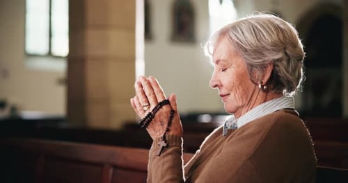 Rosary, prayer and senior woman in church with faith, gratitude and spiritual respect at funeral