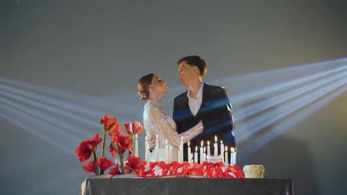 Romantic Couple Embracing at Candlelit Wedding Celebration