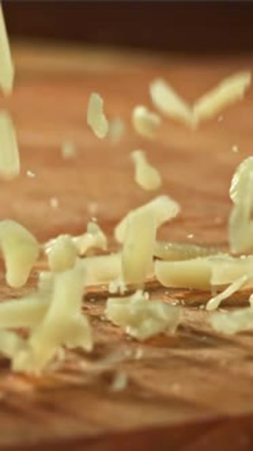 Grated Cheese Falls on a Wooden Board Filmed on a Highspeed Camera at 1000 Fps