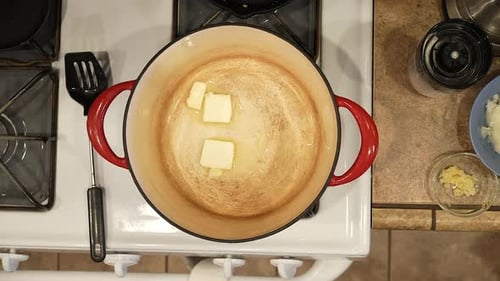 Measuring and melting butter in a pot in preparation for a homemade recipe - overhead view WILD RICE