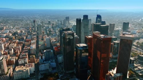Flying closer to the group of skyscrapers in the midtown of LA, California, USA.