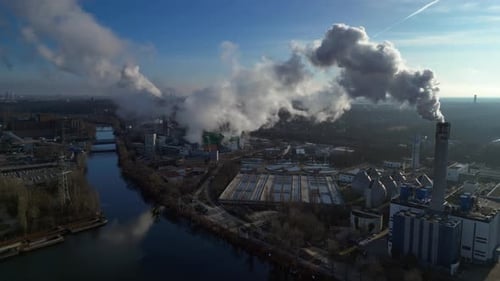 Waste energy plant factory with smoke chimney. Dramatic aerial view flight drone