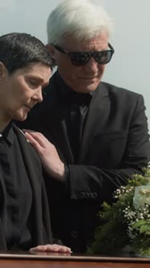Mourning Woman Comforted at Funeral Ceremony