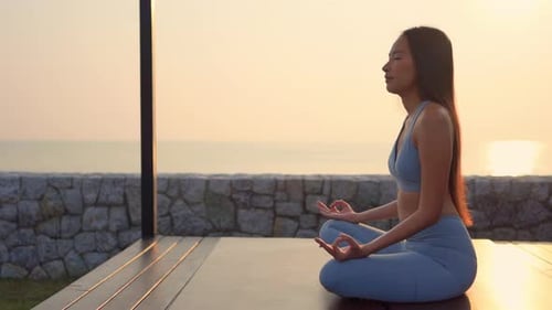 Meditation - Yoga asian woman meditating at beach sunset