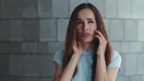 Portrait of Upset Businesswoman Talking on Cellphone at Urban Street. Sad Professional