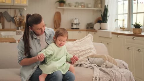 Woman and Child Sitting Together on Couch Indoors