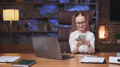 Pretty Female Child Counting Money in Stylish Office